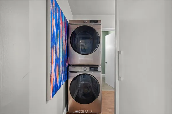 a view of a bedroom with washer and dryer