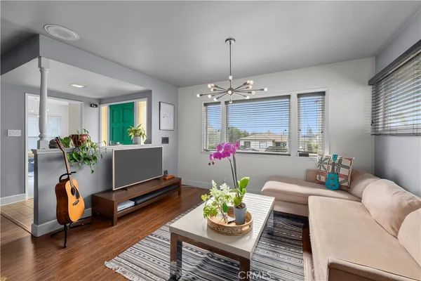 a living room with furniture and a chandelier