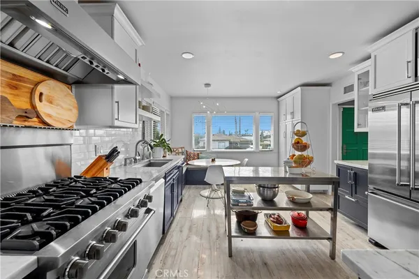 a kitchen with stainless steel appliances granite countertop a stove and a refrigerator