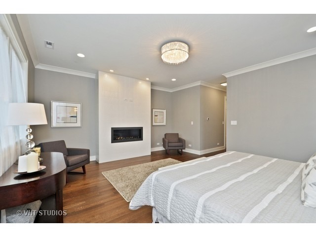 1324 West Melrose Street Chicago, IL 60657 - Photo 12 of 20 a bedroom with a bed and wooden floor