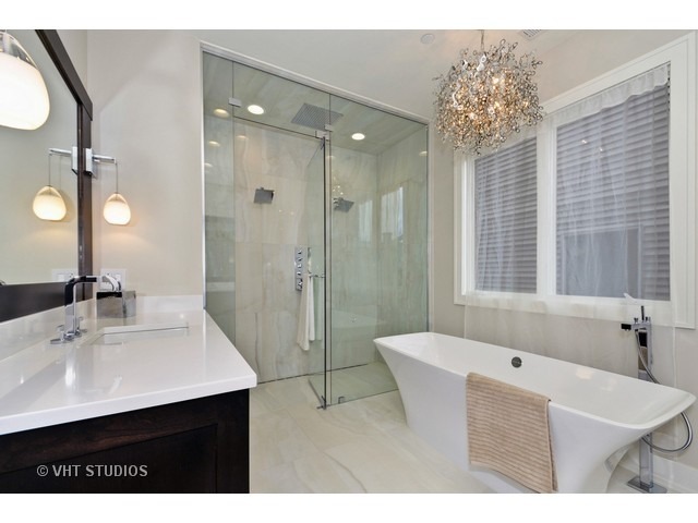 1324 West Melrose Street Chicago, IL 60657 - Photo 13 of 20 a bathroom with a sink vanity granite tub shower and a mirror