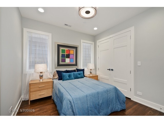 1324 West Melrose Street Chicago, IL 60657 - Photo 15 of 20 a bedroom with a bed and a chandelier