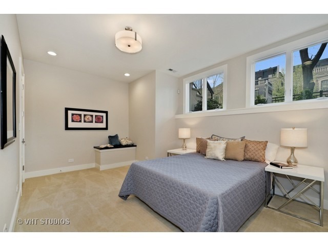 1324 West Melrose Street Chicago, IL 60657 - Photo 17 of 20 a bedroom with a bed and glass windows