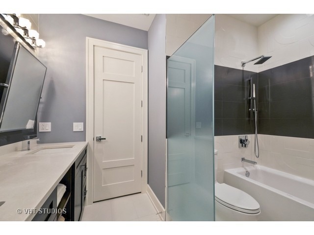 1324 West Melrose Street Chicago, IL 60657 - Photo 18 of 20 a bathroom with a tub sink and mirror