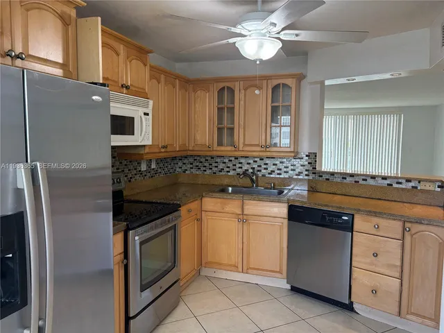 a kitchen with cabinets appliances and a sink