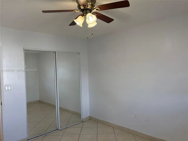 a view of an empty room with a fan