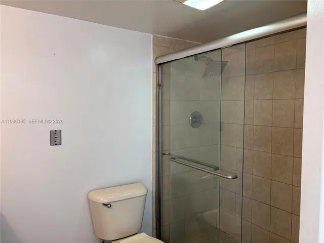 a bathroom with a toilet and shower