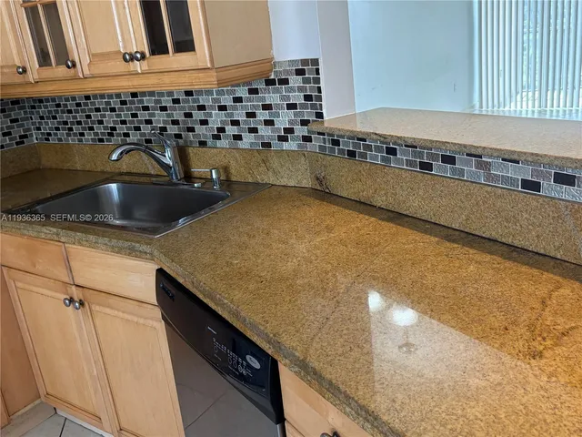 a kitchen with a sink and cabinets