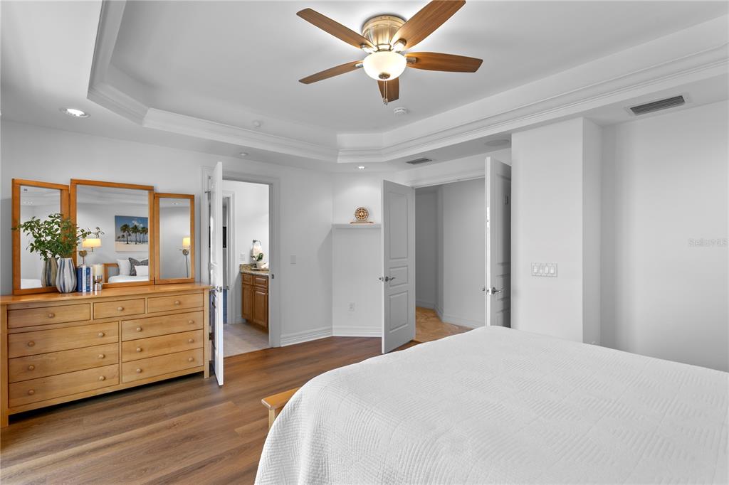 19730 Gulf Boulevard, Unit 400 Indian Rocks Beach, FL 33785 - Photo 59 of 90 a bedroom with a bed and a chandelier
