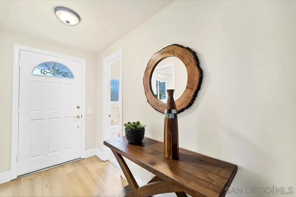 3563 Oak Cliff Drive Fallbrook, CA 92028 - Photo 13 of 43 a view of a hallway with paintings on the wall