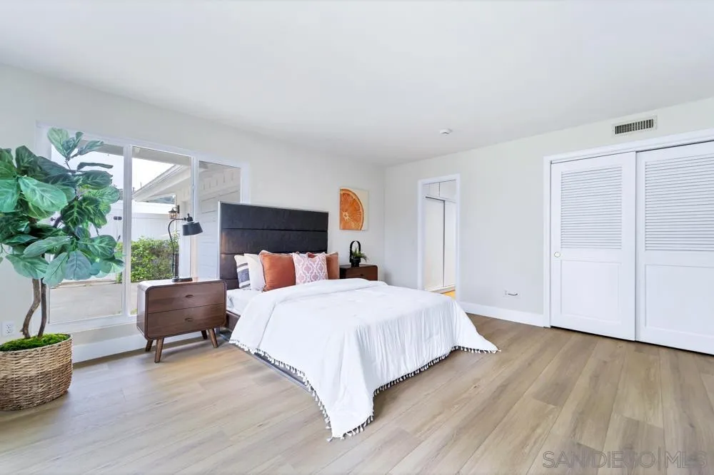 3563 Oak Cliff Drive Fallbrook, CA 92028 - Photo 23 of 43 a bedroom with a large bed and a potted plant