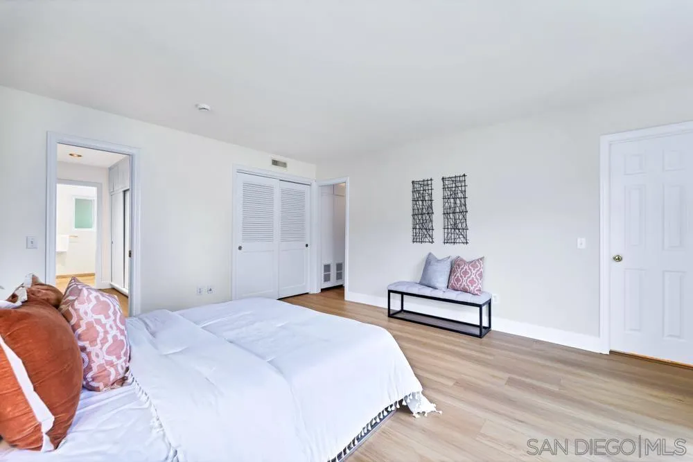 3563 Oak Cliff Drive Fallbrook, CA 92028 - Photo 24 of 43 a bedroom with a bed and wooden floor
