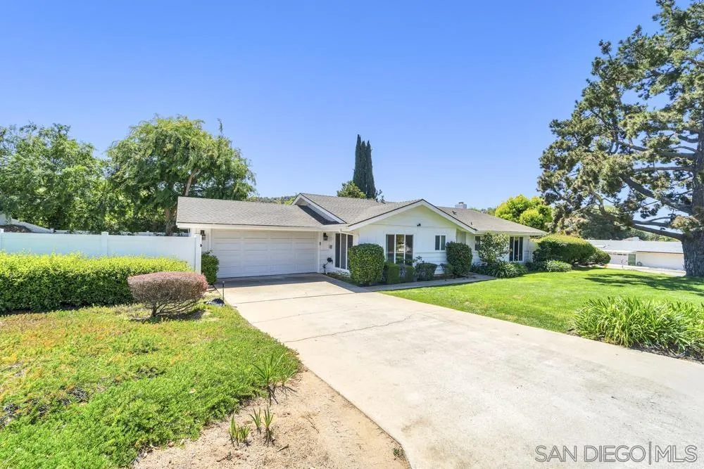 3563 Oak Cliff Drive Fallbrook, CA 92028 - Photo 37 of 43 a front view of a house with a yard and garage