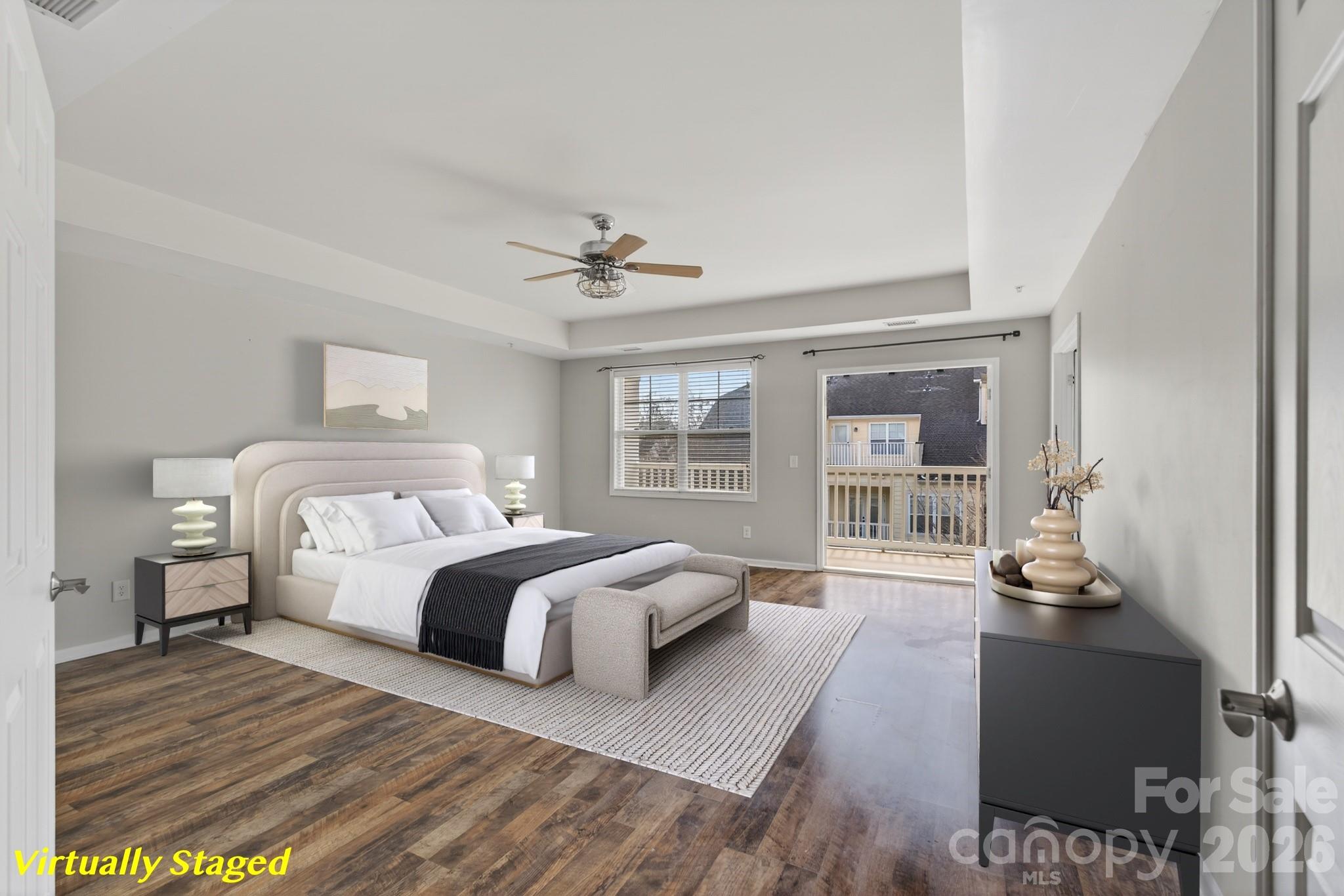 114 Inlet Point Drive Tega Cay, SC 29708 - Photo 17 of 40 a spacious bedroom with a bed a couch and large window