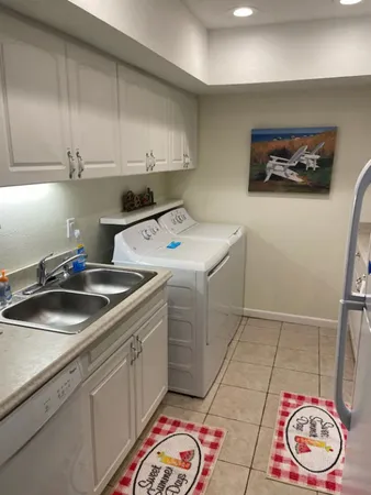 a kitchen with a sink a stove and cabinets