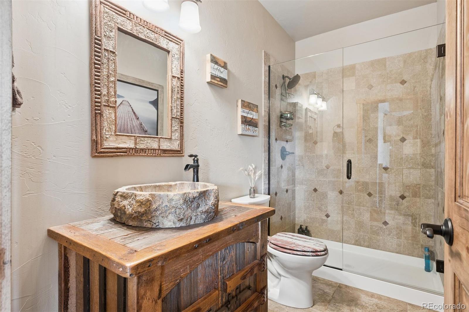 2894 County Road 43 Bailey, CO 80421 - Photo 18 of 40 a bathroom with a sink a toilet and shower