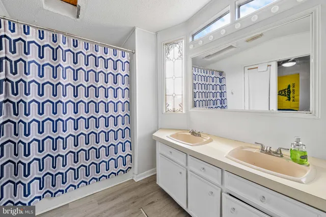 a bathroom with a sink a vanity and a shower