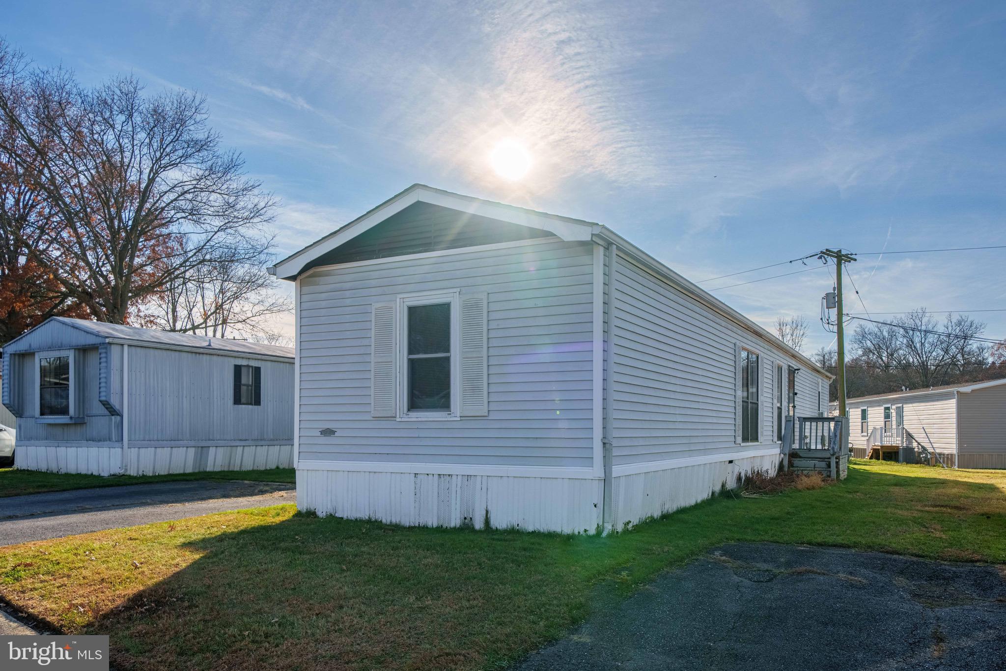 57 Gypsum Drive, Unit 195 Newark, DE 19713 - Photo 18 of 19 a view of a backyard with plants and large tree