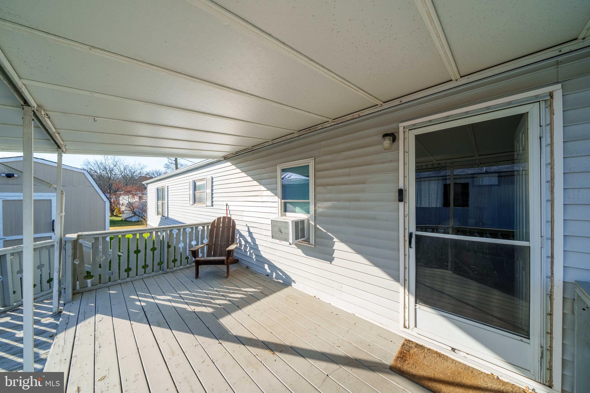 57 Gypsum Drive, Unit 195 Newark, DE 19713 - Photo 3 of 19 a view of a patio with table and chairs with wooden floor