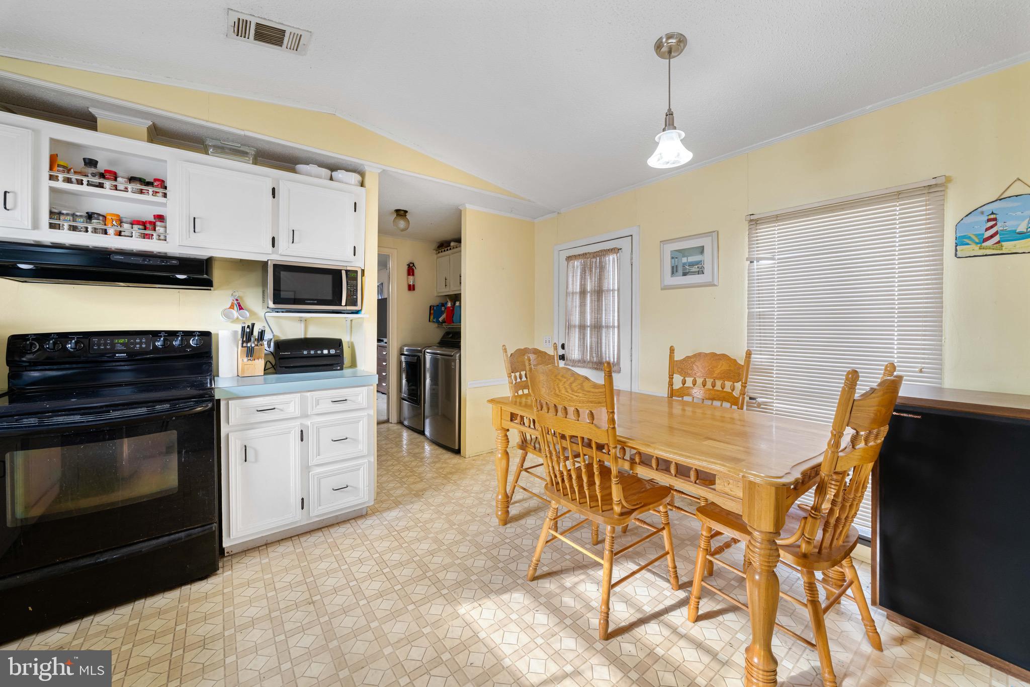 57 Gypsum Drive, Unit 195 Newark, DE 19713 - Photo 7 of 19 a view of a kitchen with a dining table and chairs