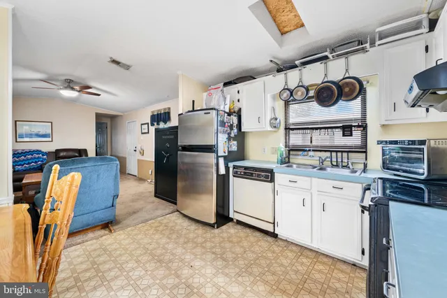 a kitchen with granite countertop a refrigerator and a stove