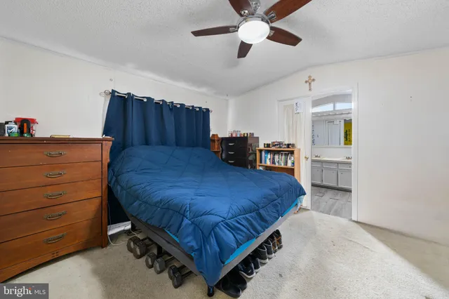 a bedroom with a bed dresser and a window