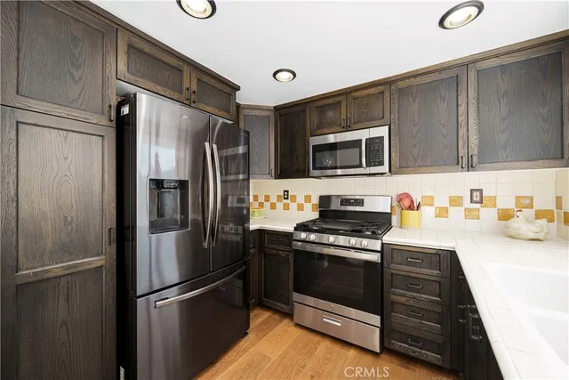 a kitchen with a refrigerator stove and sink
