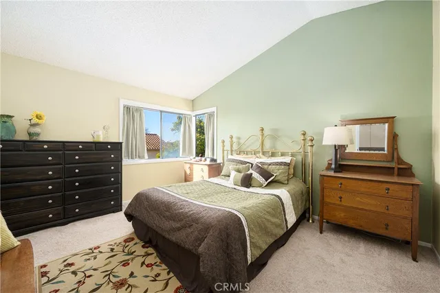 a bed room with a bed and a television