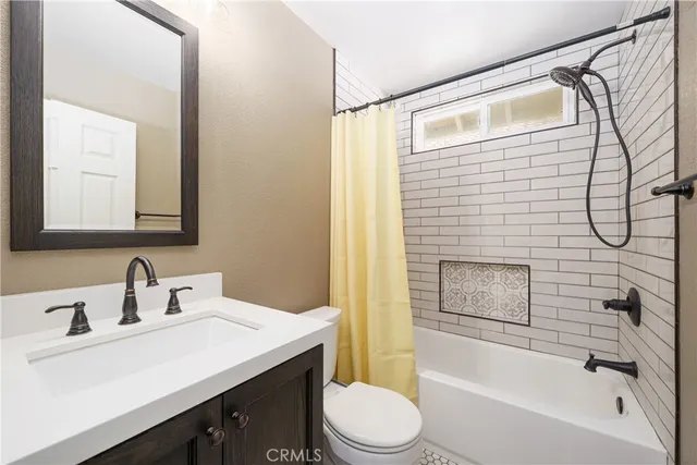 a view of a chair and tables in the patio