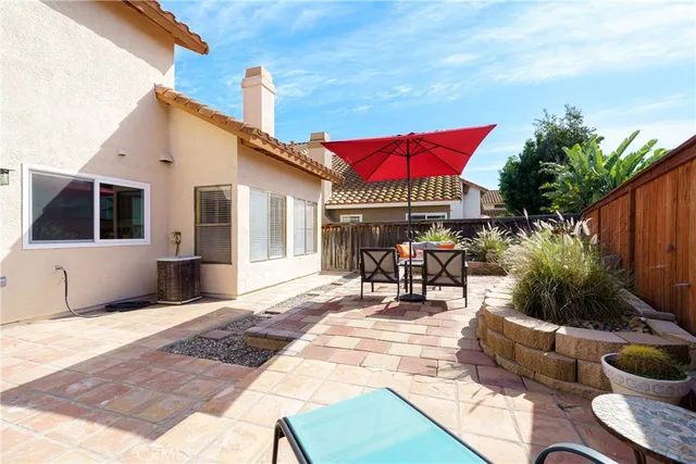 an aerial view of house with yard and mountain view in back