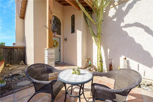 a view of a balcony with furniture and a potted plant