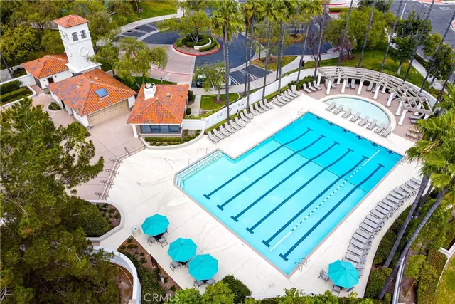 an aerial view of a house a yard swimming pool and outdoor seating