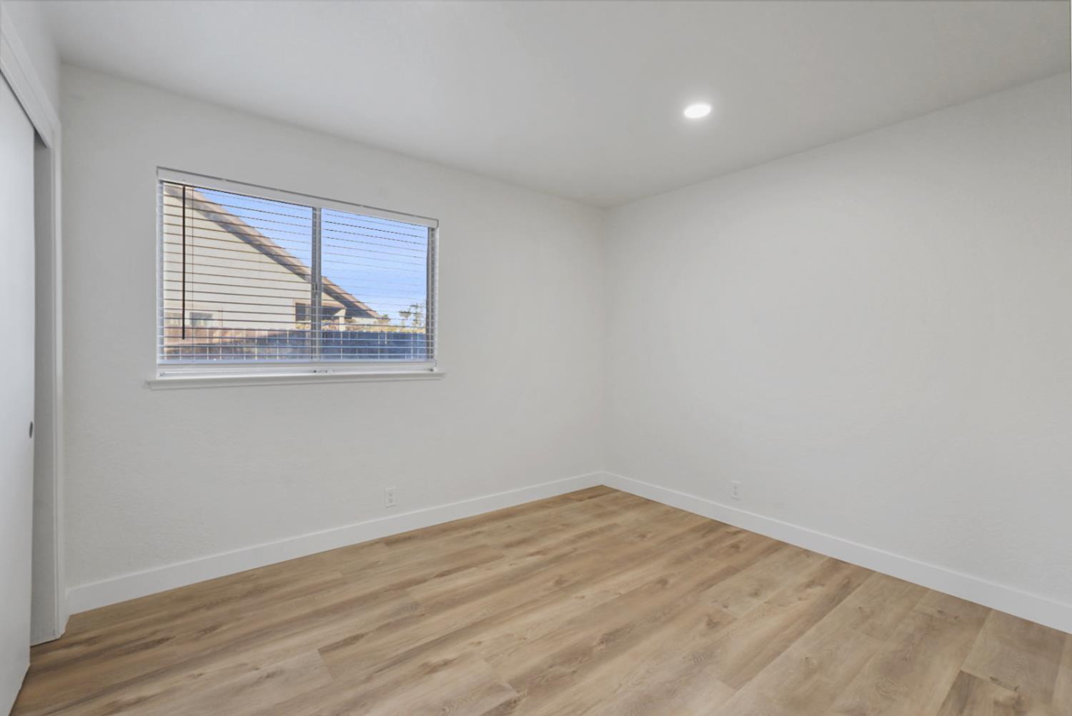 1128 Raymond Drive Modesto, CA 95351 - Photo 18 of 32 wooden floor in an empty room with a window