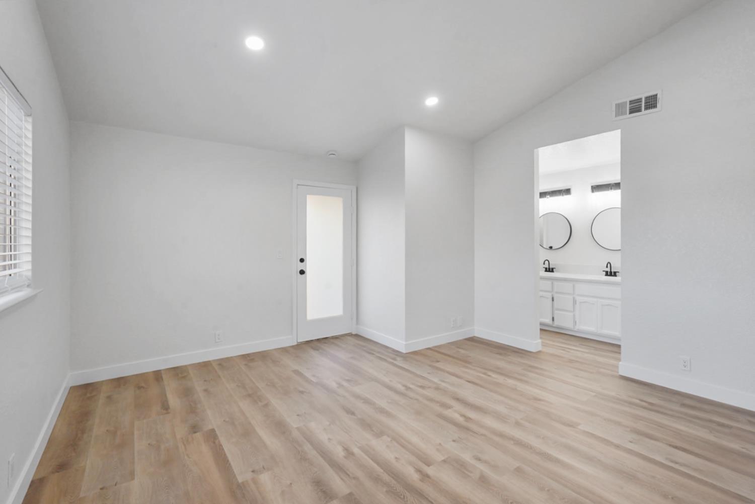 1128 Raymond Drive Modesto, CA 95351 - Photo 20 of 32 wooden floor in an empty room with a window