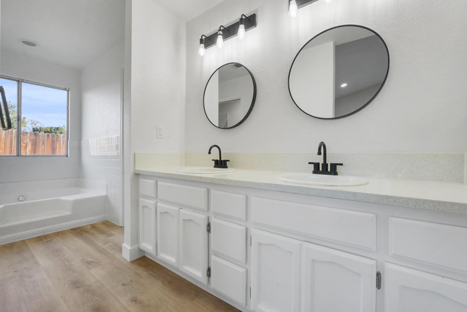 1128 Raymond Drive Modesto, CA 95351 - Photo 21 of 32 a bathroom with a double vanity sink and a mirror