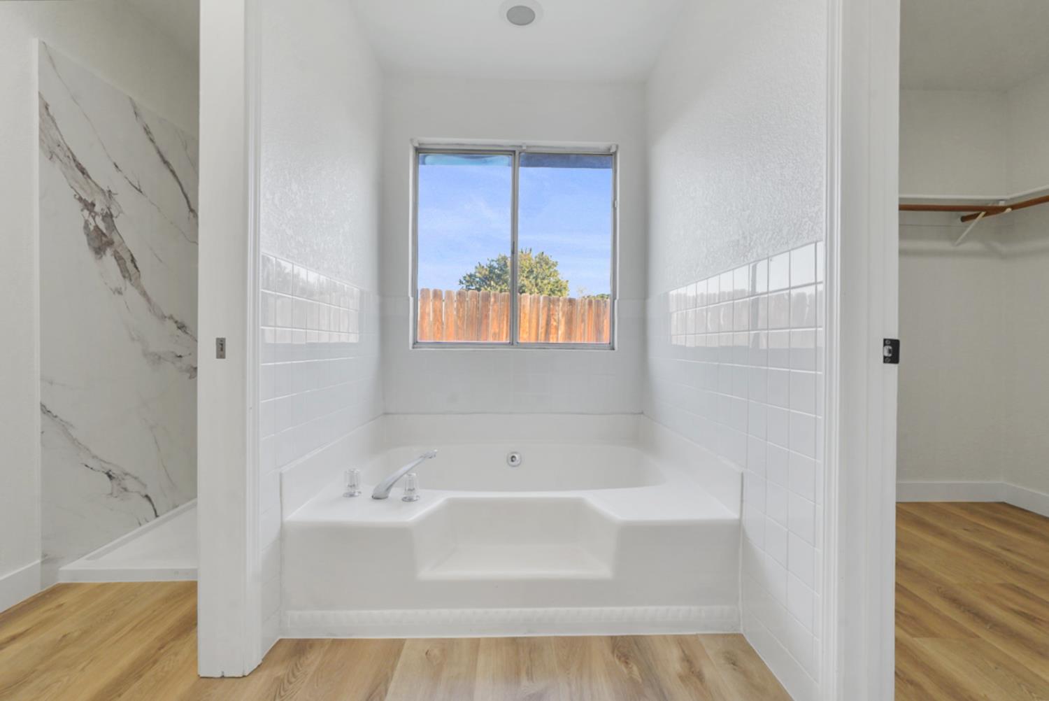 1128 Raymond Drive Modesto, CA 95351 - Photo 22 of 32 a bathroom with a tub shower and sink