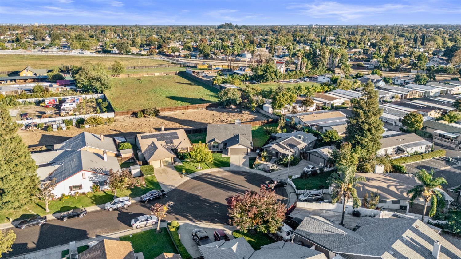1128 Raymond Drive Modesto, CA 95351 - Photo 32 of 32 an aerial view of a city with lots of residential buildings ocean and mountain view in back