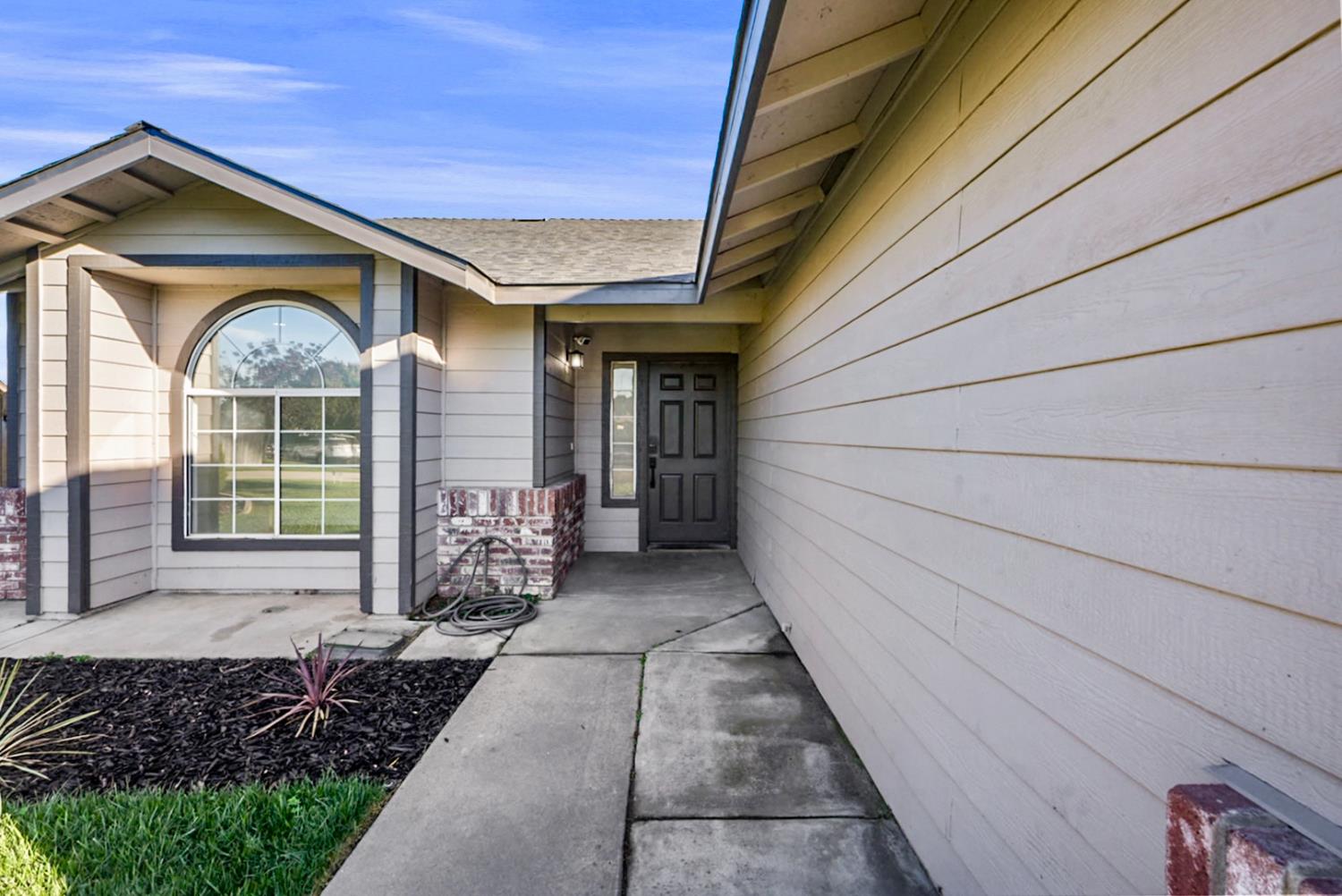 1128 Raymond Drive Modesto, CA 95351 - Photo 5 of 32 a front view of a house with a yard