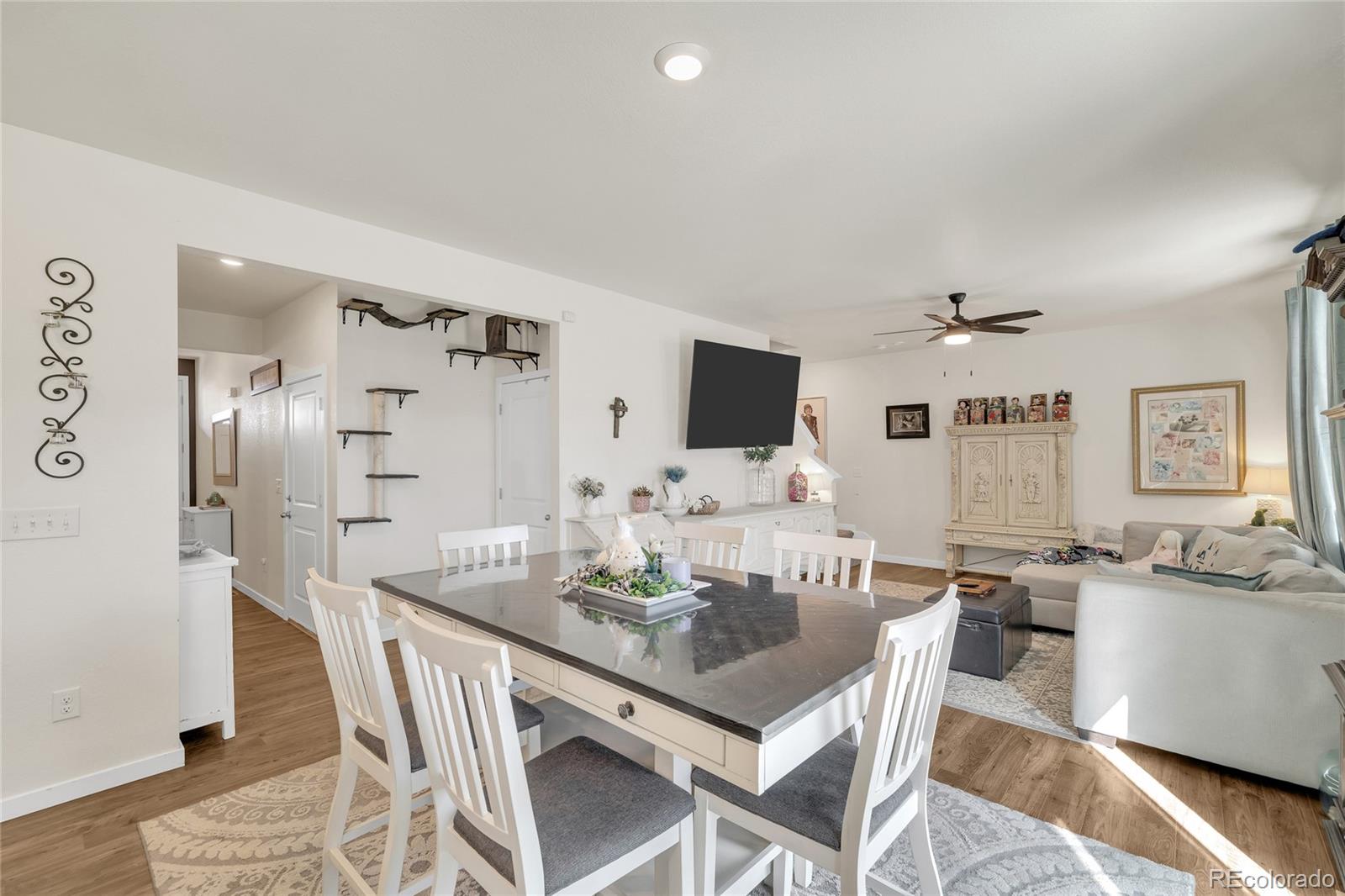 45824 Silverdrop Avenue Bennett, CO 80102 - Photo 17 of 49 a view of a dining room with furniture