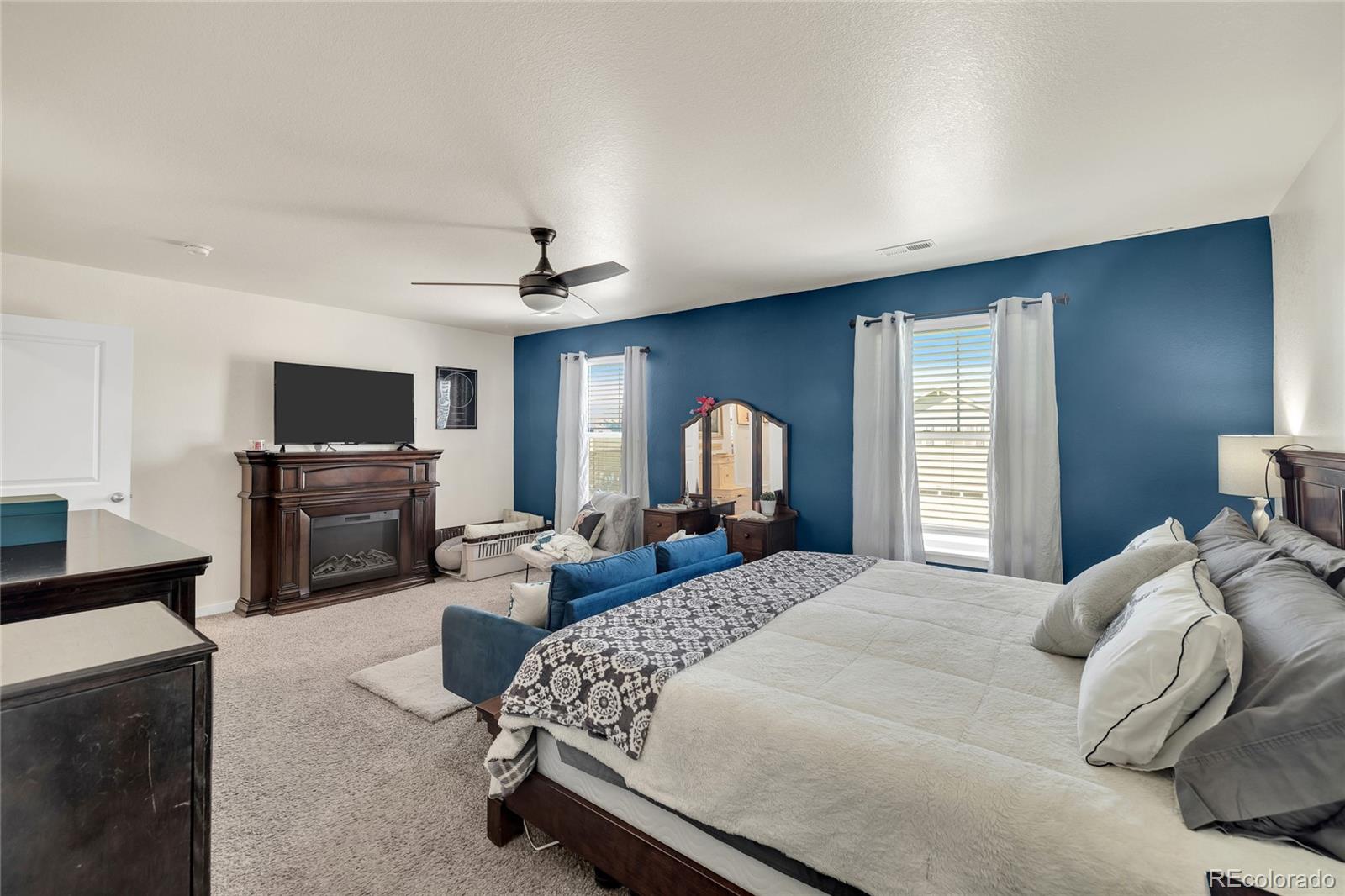 45824 Silverdrop Avenue Bennett, CO 80102 - Photo 30 of 49 a bedroom with bed a flat tv screen and a dresser