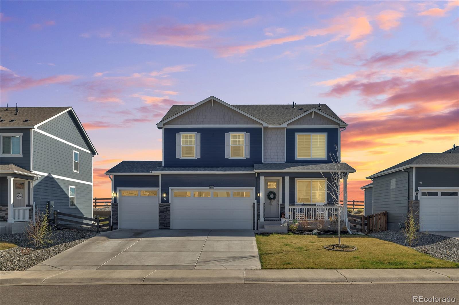 45824 Silverdrop Avenue Bennett, CO 80102 - Photo 3 of 49 a front view of a house with a garden and yard