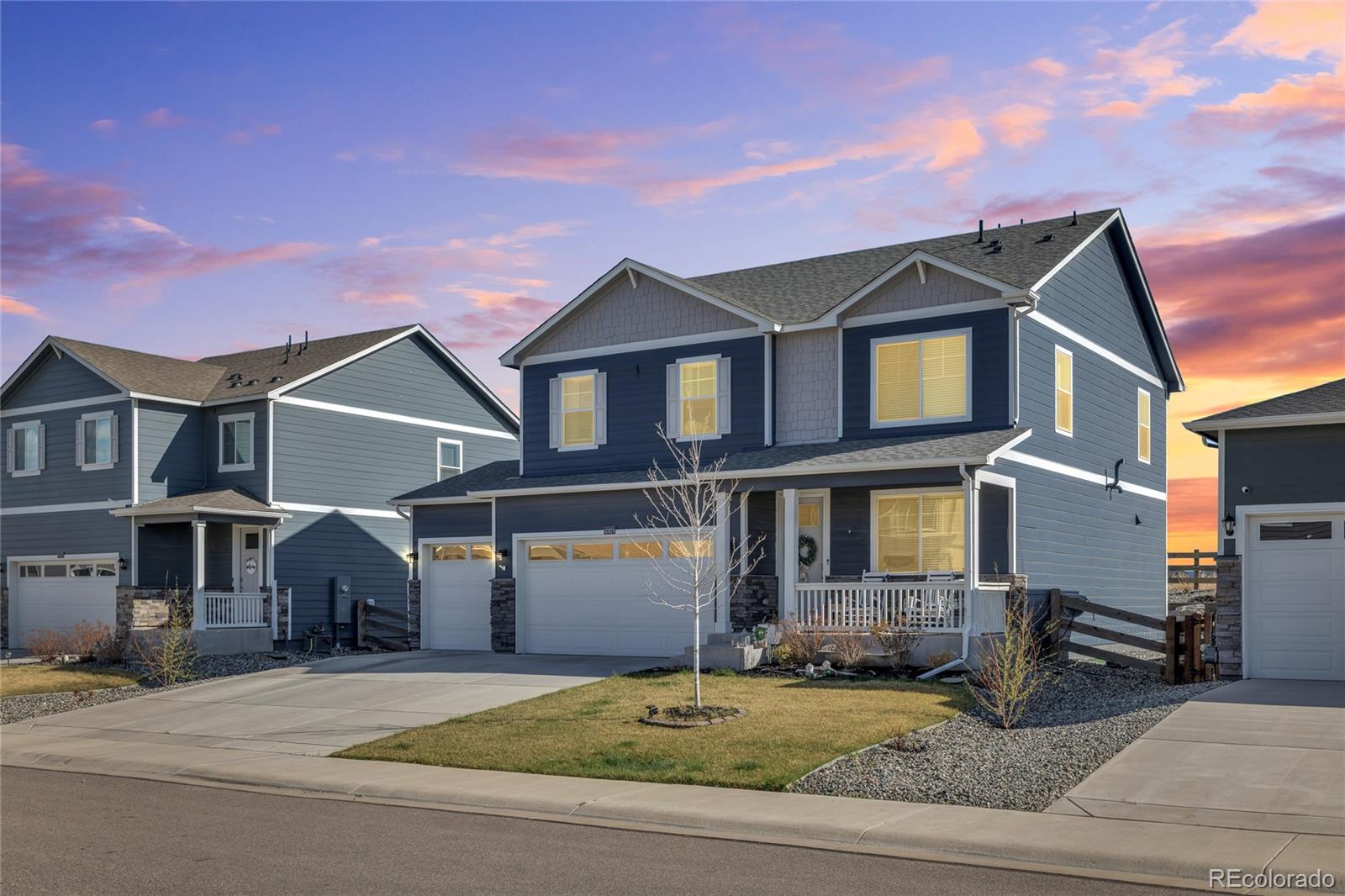 45824 Silverdrop Avenue Bennett, CO 80102 - Photo 4 of 49 a front view of a house with garden