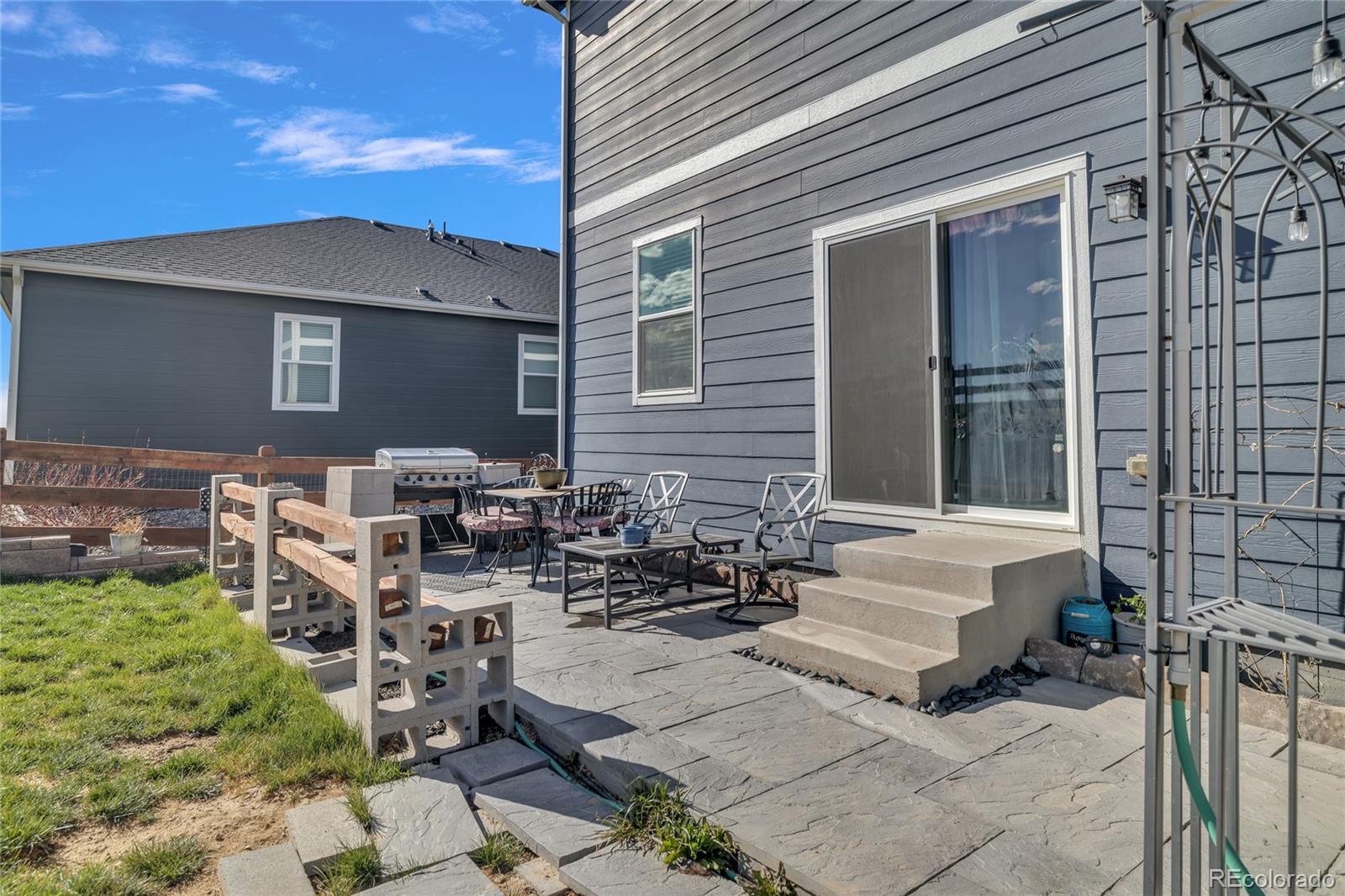 45824 Silverdrop Avenue Bennett, CO 80102 - Photo 42 of 49 a view of a patio with chairs and plants