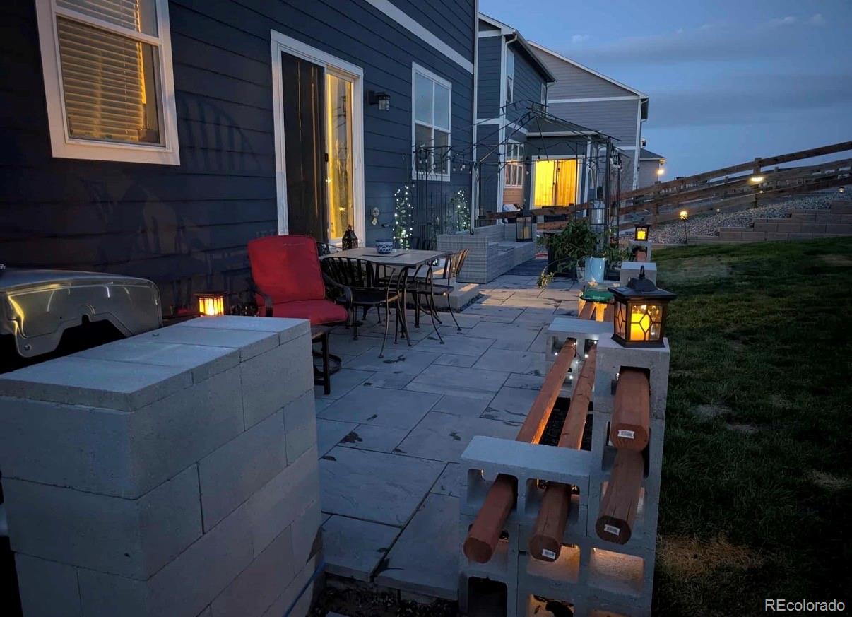 45824 Silverdrop Avenue Bennett, CO 80102 - Photo 47 of 49 a view of a house with a chairs in patio