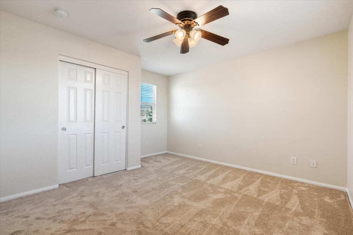 82732 Castleton Drive Indio, CA 92203 - Photo 29 of 45 an empty room with closet and a chandelier fan