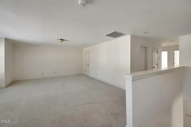 a view of a big room with closet and windows