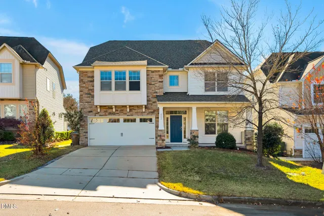 a view of a white house with a swimming pool