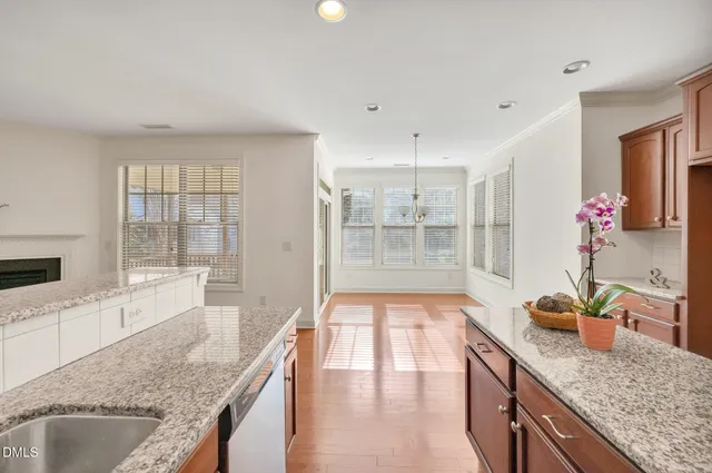a large kitchen with granite countertop a large counter top space and living room
