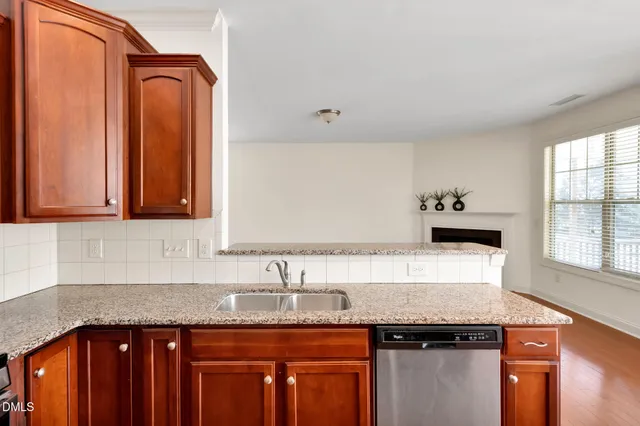 a kitchen with granite countertop a sink and a stove