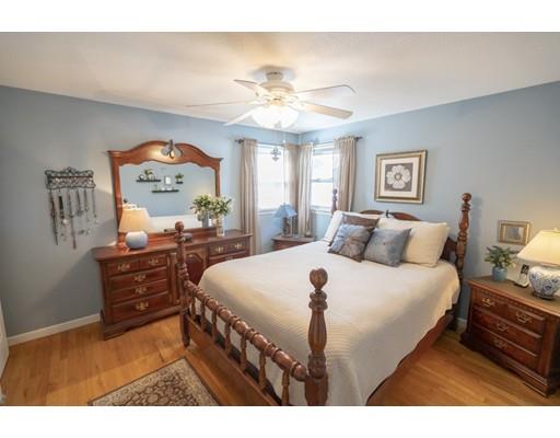 14 Rachel Street Springfield, MA 01129 - Photo 15 of 25 a bed room with a bed mirror and a chandelier